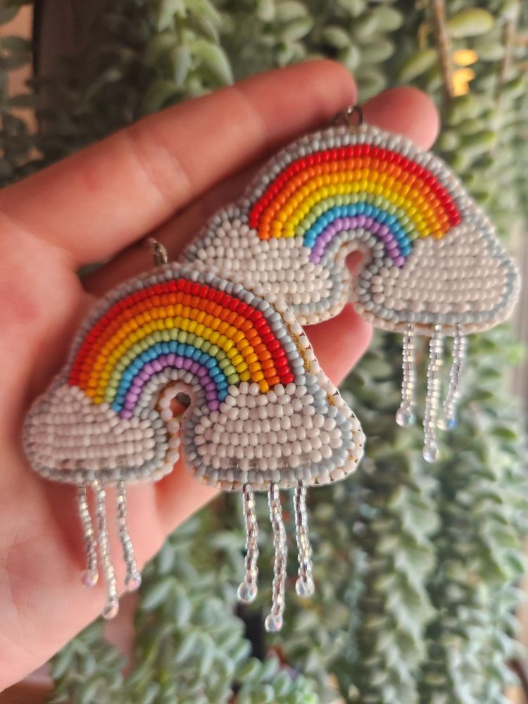 Beaded rainbow earrings, they have beaded raindrops hanging from their clouds. 