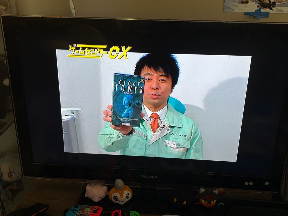 Arino holding up a Super Famicom copy of Clock Tower