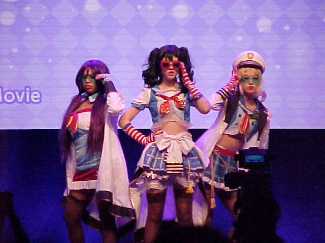 A cosplay performance from Anime Boston's 2022 Idol Showcase, featuring Nico, Eri, and Nozomi from Love Live.
