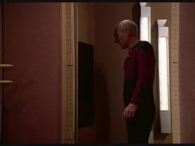 Picard from tng standing in front of a replicator