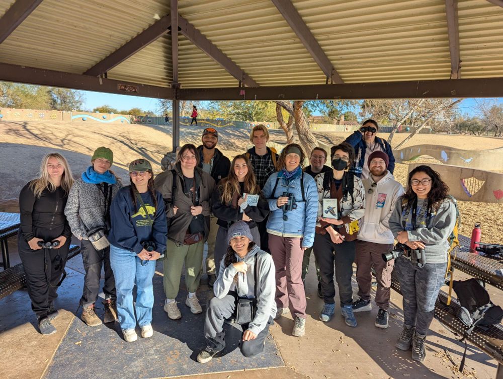 Students with binoculars and field guides for group photo