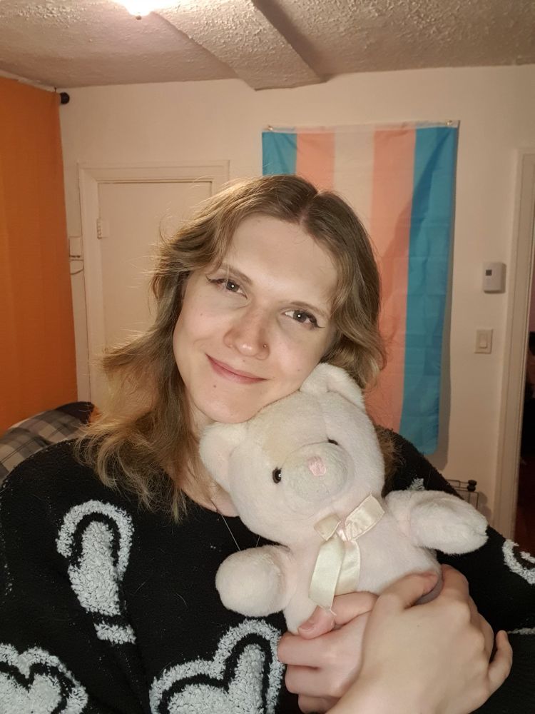 Fiona holding her pink teddy bear, Pinkie.