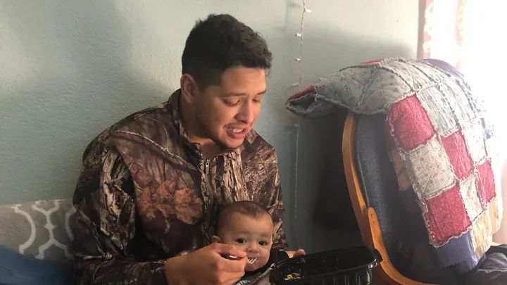 the pig feeding a small child scraps of a store-bought rotisserie chicken with a plastic fork