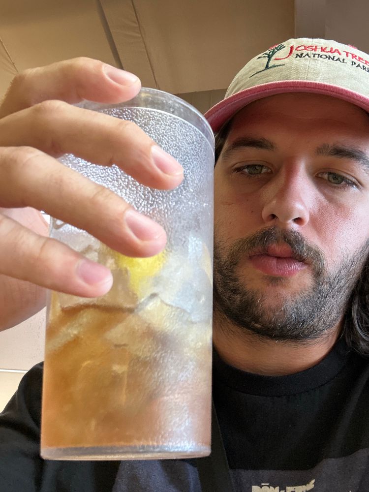 Me holding a nearly finished cup of lemon iced tea