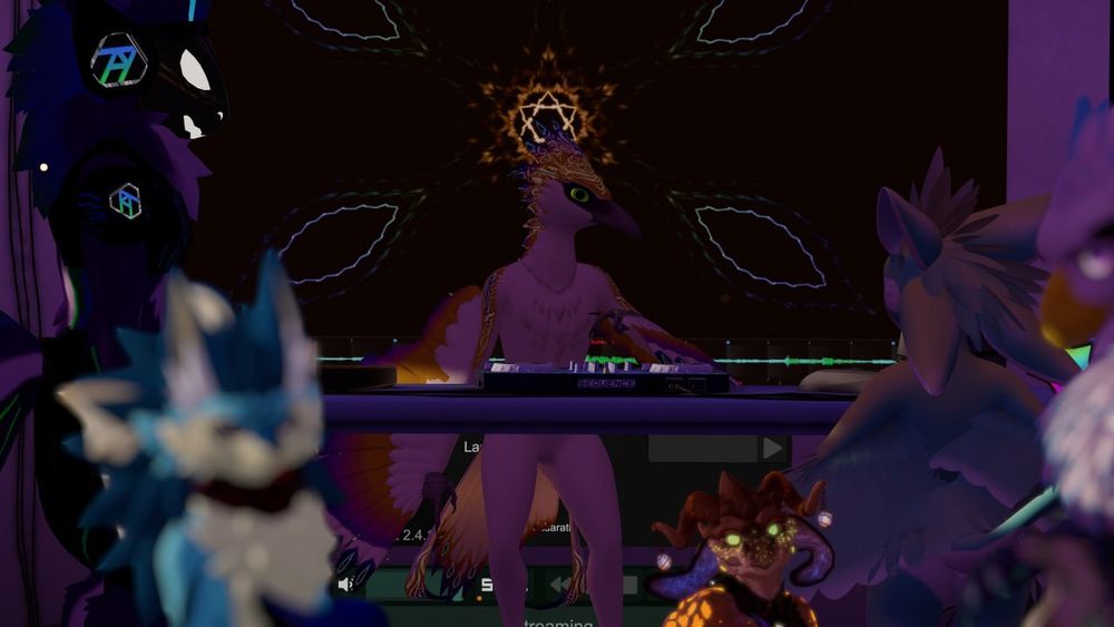 A picture taken in VRChat with a bird avatar in the center of the frame, graphics are on the screen behind