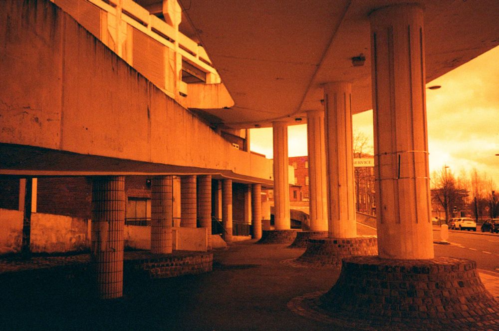 Very red photographs of a 1960s car park from using film reversed in the camera