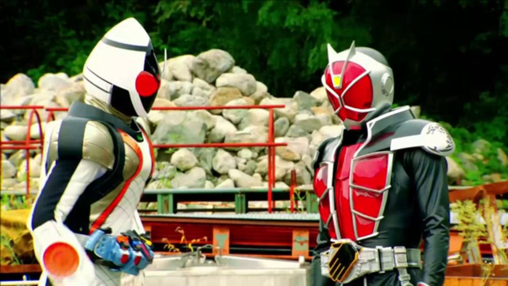 two kamen riders are standing next to each other in front of rocks