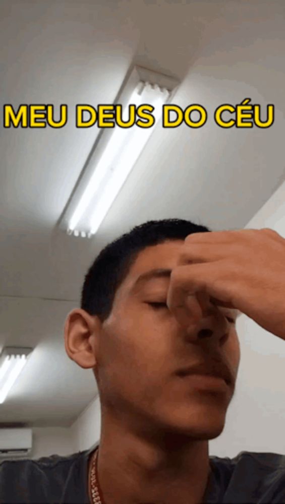 a man holds his nose in front of a sign that says meu deus do céu