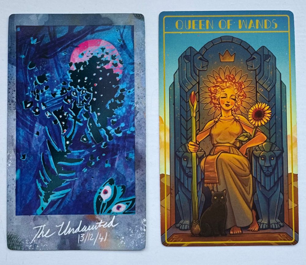 The Undaunted shows a wee fey beastie, shiny blue on a darker blue background with a pink sun in the background. This card was made by Shan
Bennion.

The Queen of Wands shows a female figure sitting on a throne, holding a sunflower and a tall wand a little like a flower bud stalk. This card was made by Temple of Tales.