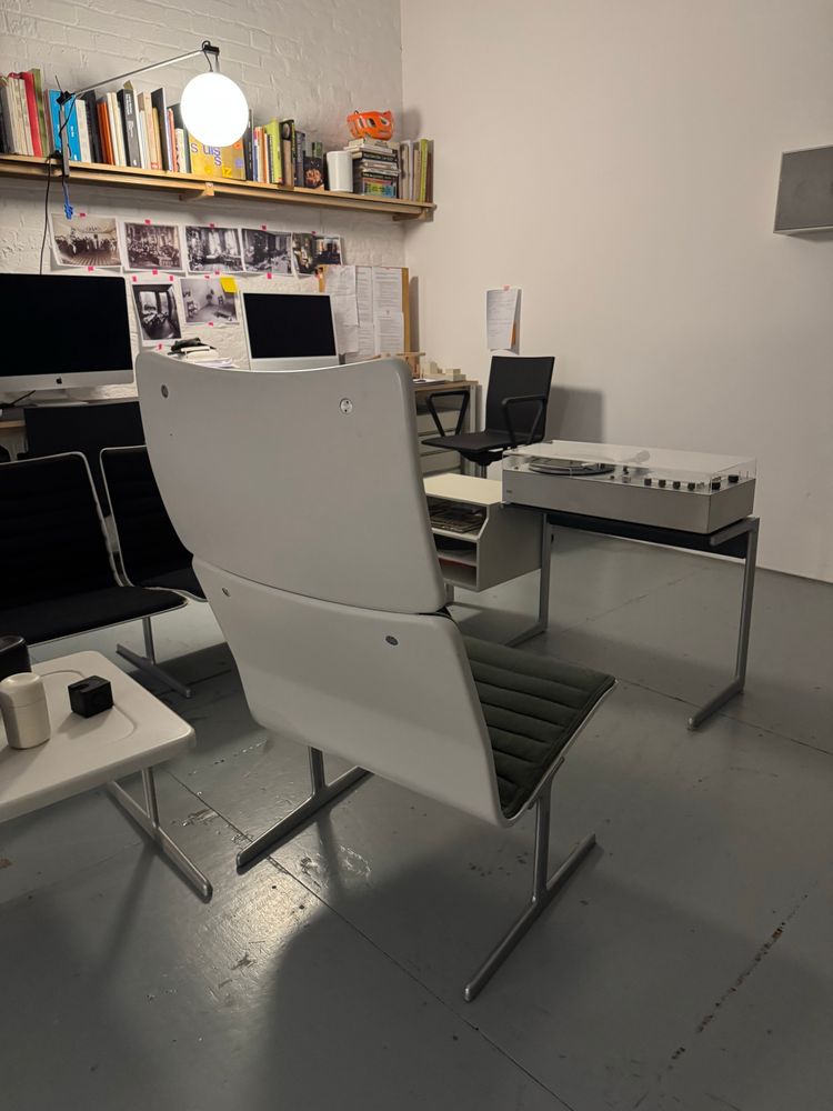The lovely Zapf 601/2 RZ 60 high back lounge chair in black/ charcoal hopsack, with pair of low-back chairs behind designed by Dieter rams 1960. Floor stand mounted Braun audio unit behind.
