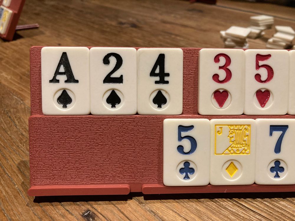 A set of rummy tiles, mid game. There are three spade tiles A, 2, 4. Reminiscent of A24 - the movie distributor 