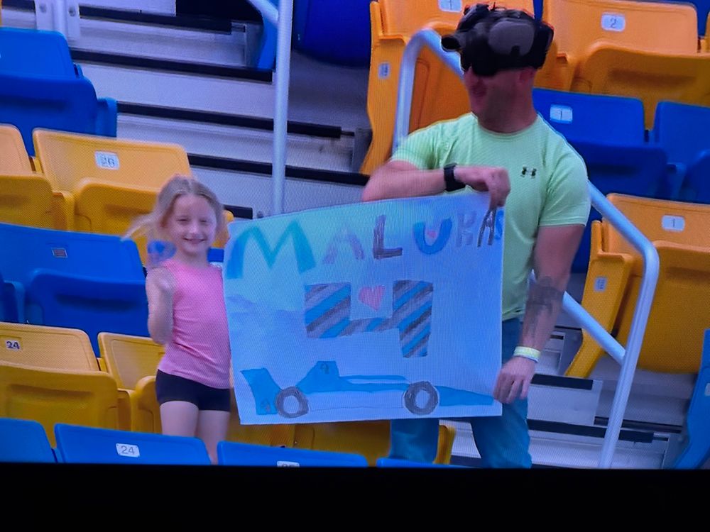 A fan made sign for driver David Malukis with the letters smushed in to fit on one line