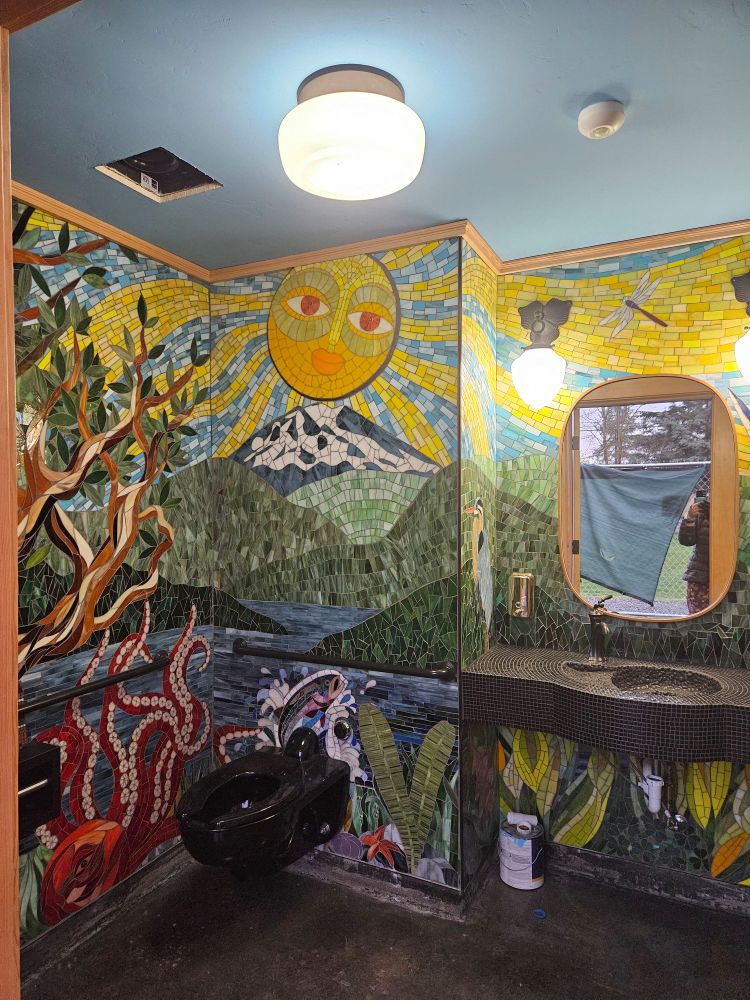 Restroom covered in mosaic art.