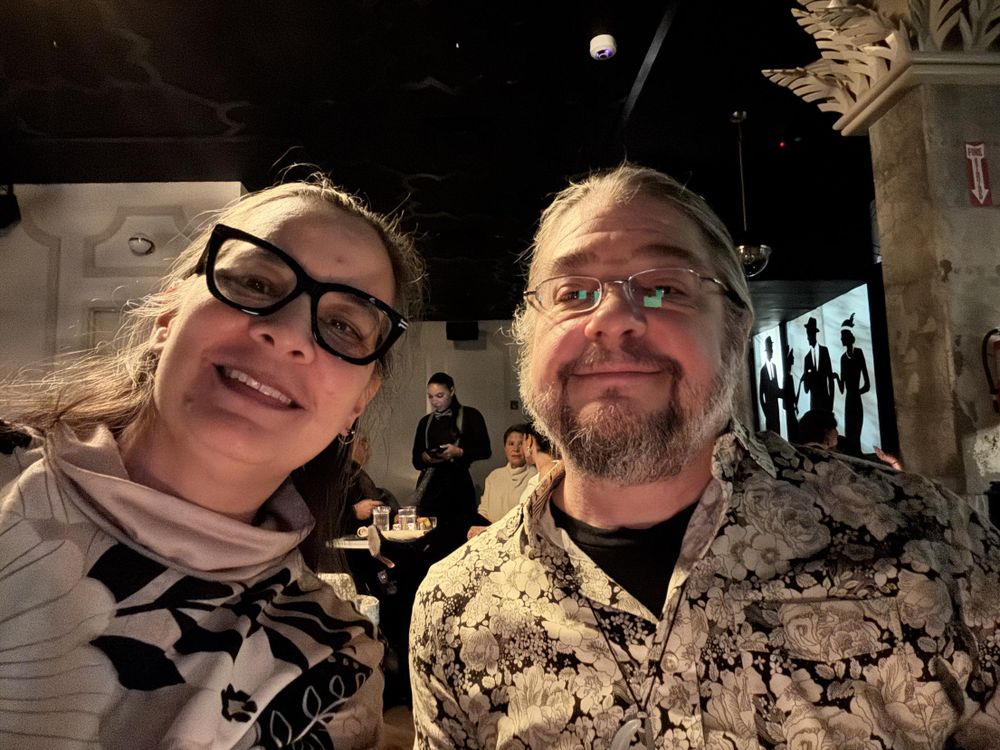 Two people having cocktails in a speakeasy 