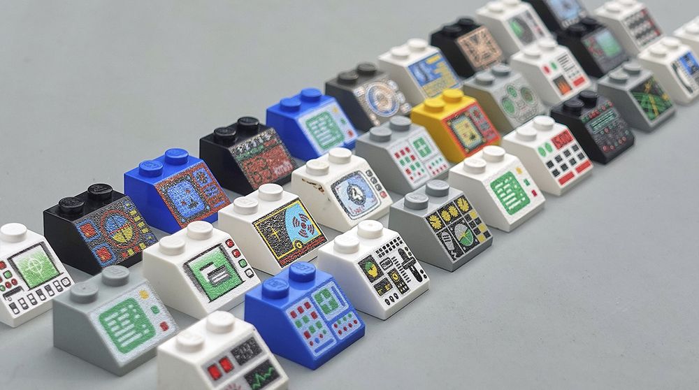 A big collection of lego bricks with printed control panels, taken from many different sets.