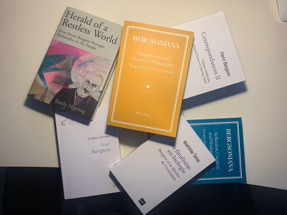 The publications mentioned in the post in a disorganised pile on a table