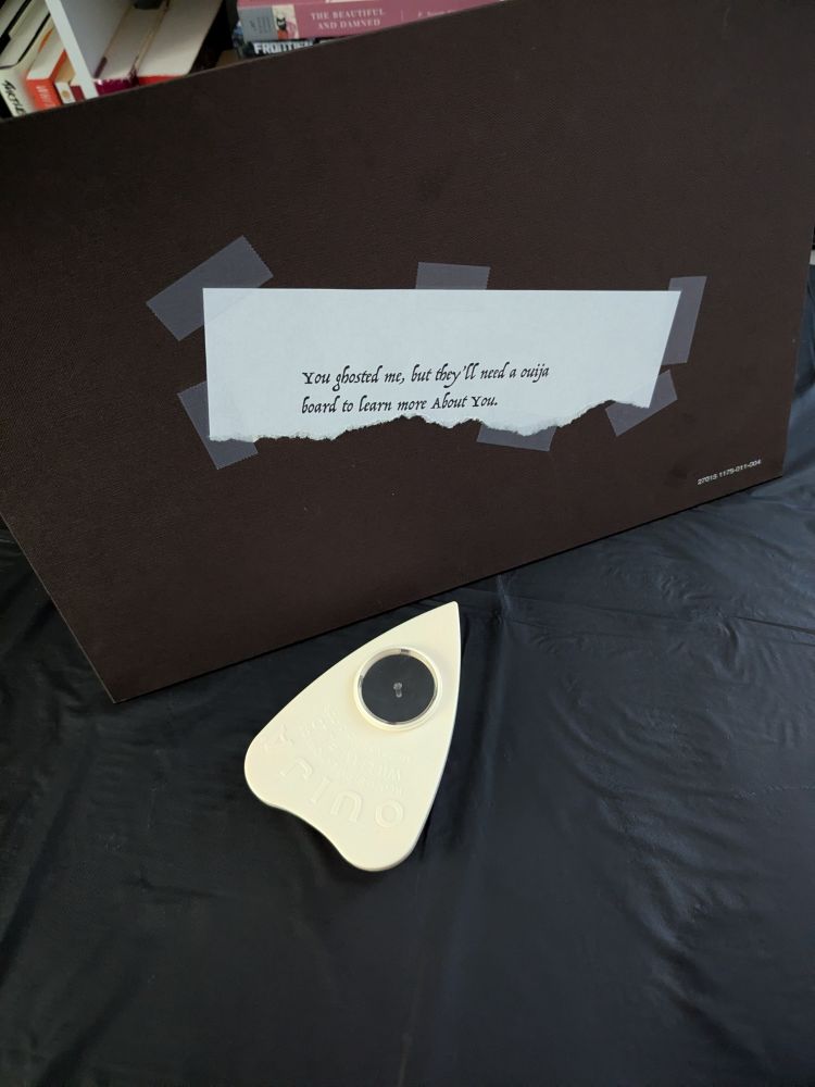 the under side of the ouija board has a note taped to it, in the folklore font it reads, "you ghosted me, but they'll need a ouija board to learn more About You"
About You is capitalized, possibly referencing the 1975 song, rumored to be about, or dedicated to, Taylor. You know, the whole, "this is about you, you know who you are, I love you" situation)