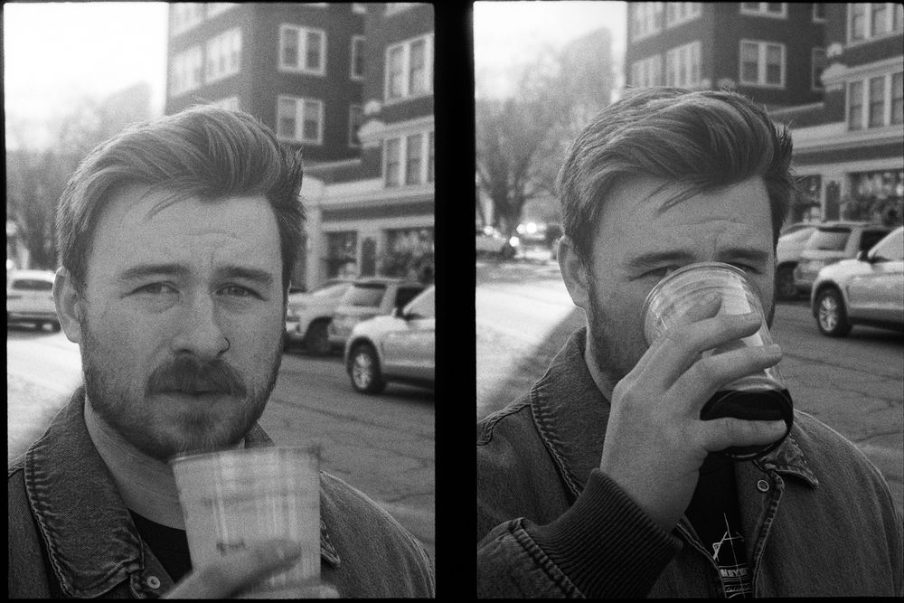 black and white diptych of a man looking over his beer glass, a city street behind him. In one frame the glass is down, in the other he’s got it to his lips but you can still see his eye over the rim.