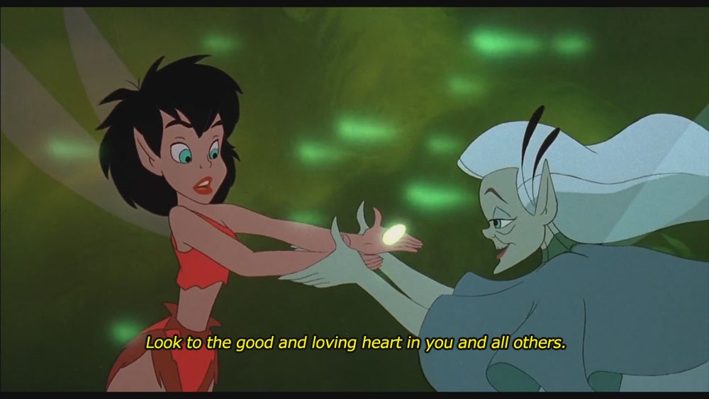 Screenshot from the 1992 animated film Ferngully: The Last Rainforest. On the left is a fairy with short black hair wearing red clothes. She looks to the right at an aged fairy with silver hair in blue who is grabbing her hands, a glowing seed floating between them. The aged fairy says: "Look to the good and loving heart in you and all others."