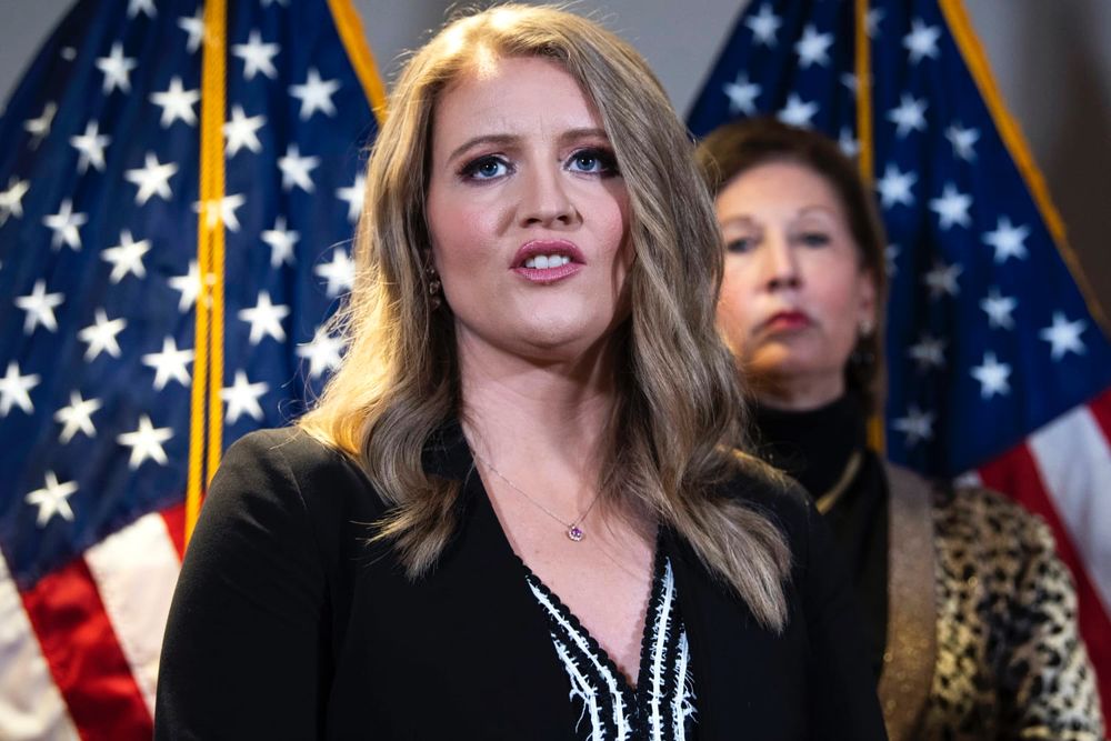 Photo of odious former Trump lawyer Jenna Ellis. In front of some flags of course.