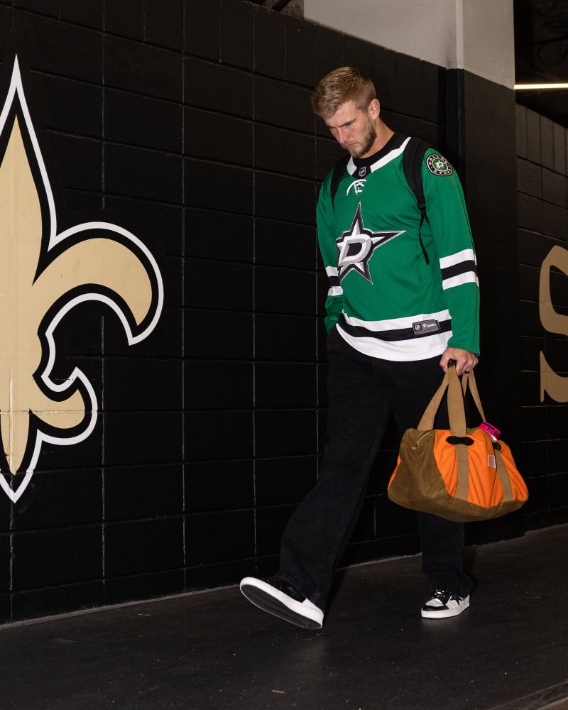 New Orleans Saints quarterback Tyler Shough wearing a Dallas Stars jersey