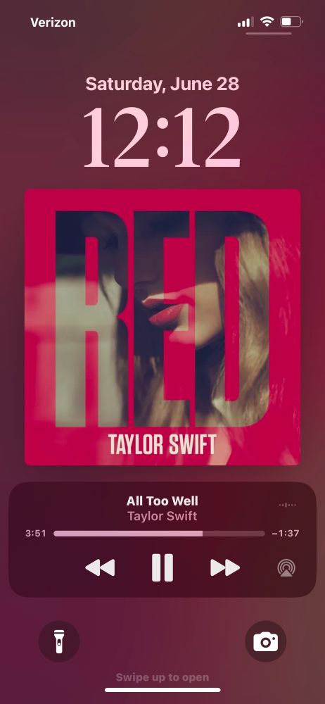 iPhone lock screen screenshot of the red album cover, all too well the og version playing at the bottom