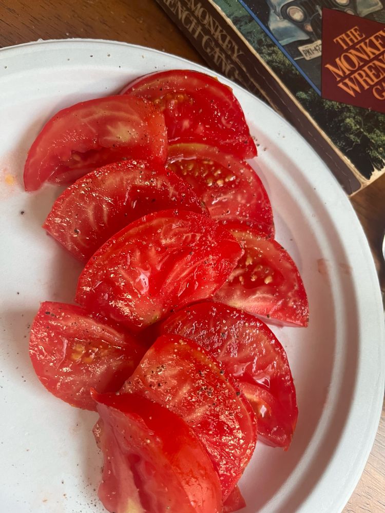 Sliced very red tomatoes on a table 