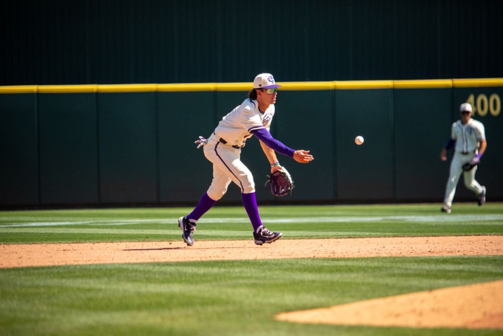 TCU shortstop Anthony Silva flips a ball during a baseball game. 
