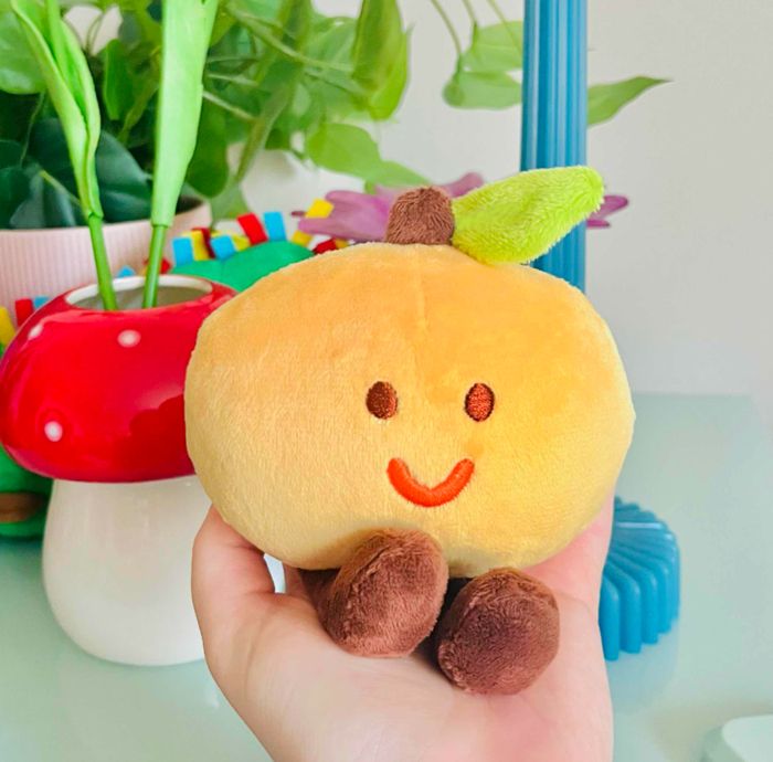smiling orange plush keychain. 