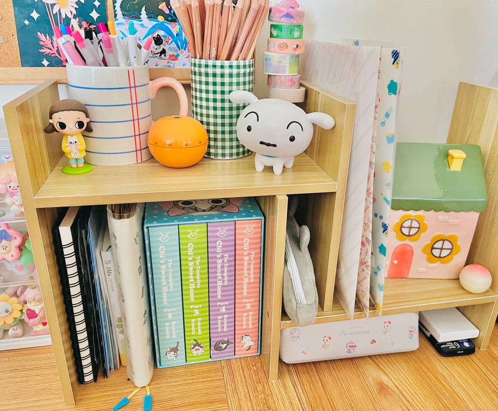a desk setup filled with colorful stationery and figures. 