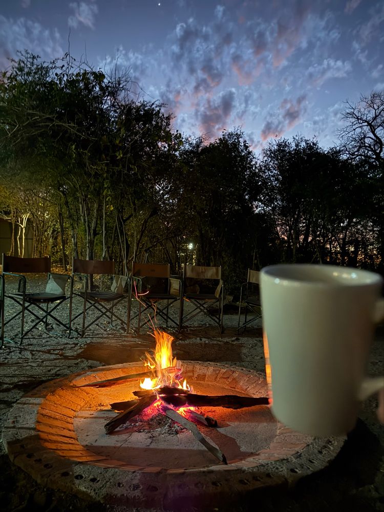 Fire, coffee and sunrise over Hwange national park
