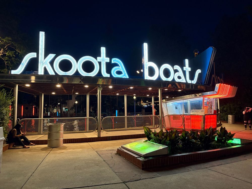 Neon signage saying “skoota boats”