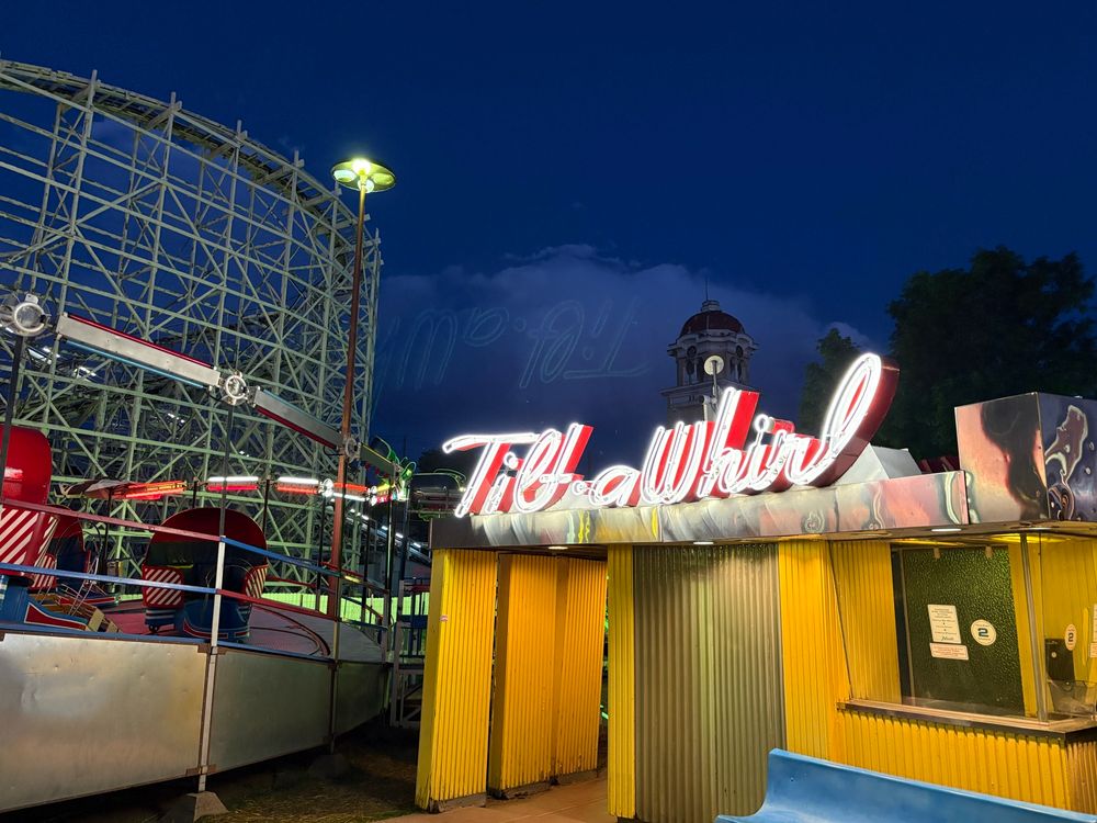 More neon, this one for the Tilt a Whirl in cursive writing. In the background is the big wooden Cyclone coaster