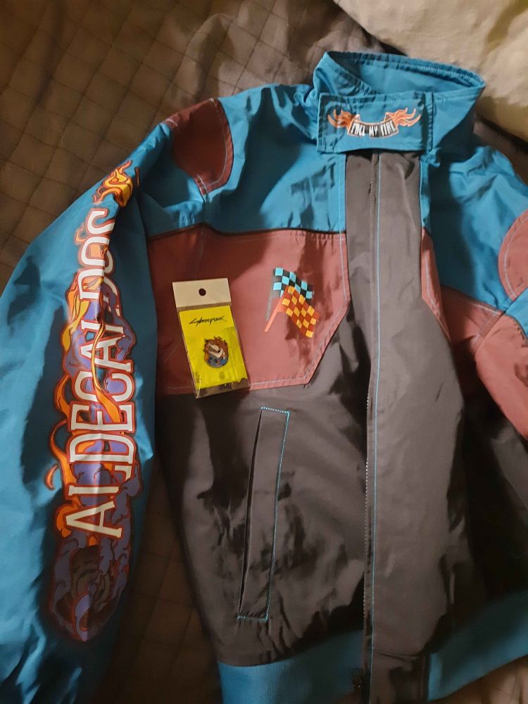 photo of the Aldecaldos racing jacket and Aldecaldos pin from Insert Coin