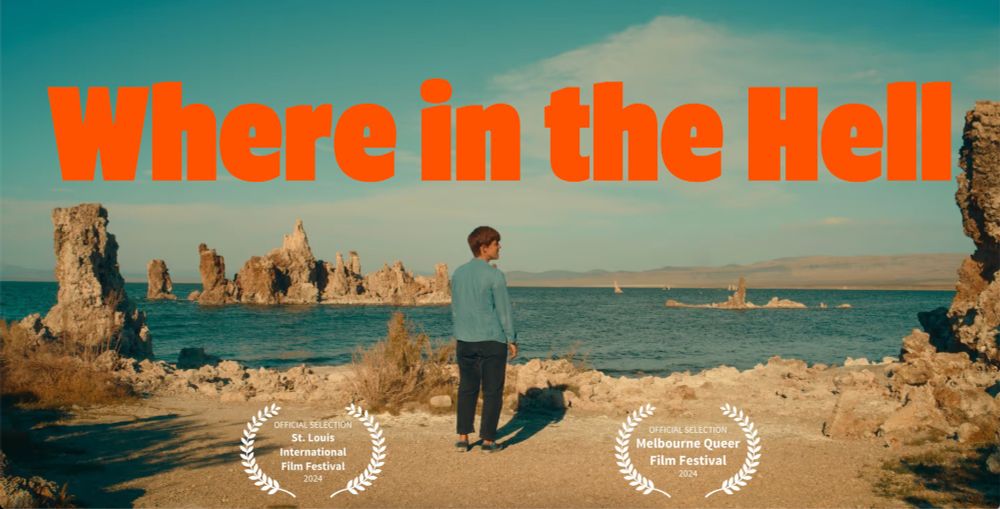 A person with short hair is looking into the distance. Behind her the vast and alien landscape of Mono Lake. Bright orange letters on the top read "Where in the Hell". At the bottom laurels for the St. Louis International Film Festival and the Melbourne Queer Film Festival.