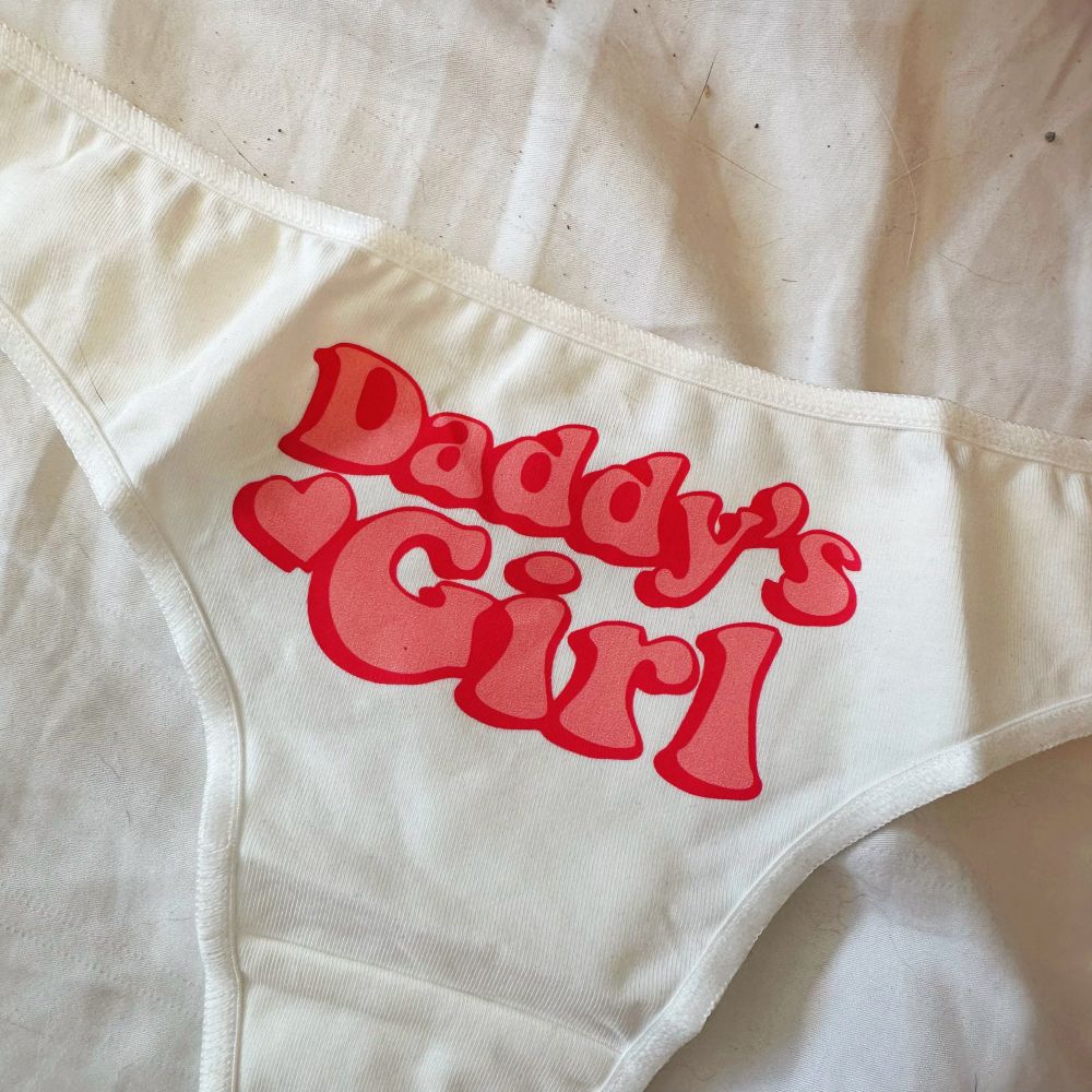 close up of the thong. it says Daddy’s Girl in a ‘70s style pink font