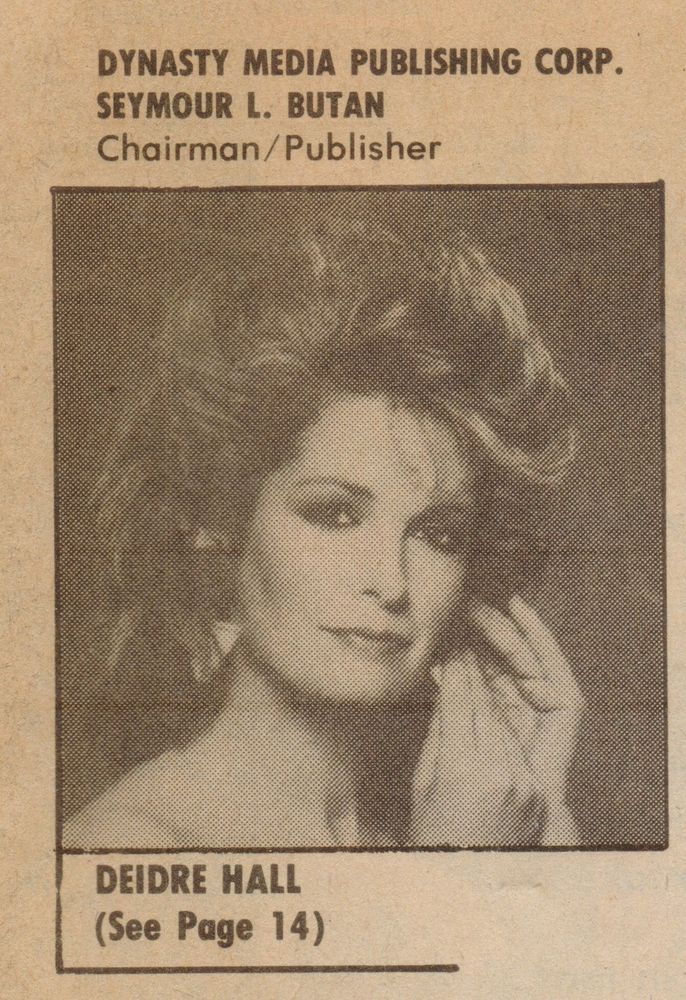Black-and-white editorial photo of Deidre Hall, soap opera icon known for her role as Marlena Evans on Days of Our Lives. She poses with voluminous 1980s hair, one hand gently touching her cheek, wearing a soft blouse with subtle shimmer. Her expression is poised and serene, evoking glamour and quiet intensity. The layout includes bold serif text above and below the image, referencing the magazine publisher and directing readers to page 14. The tone is nostalgic and dramatic, capturing Hall’s enduring legacy in daytime television. Suitable for screen readers.