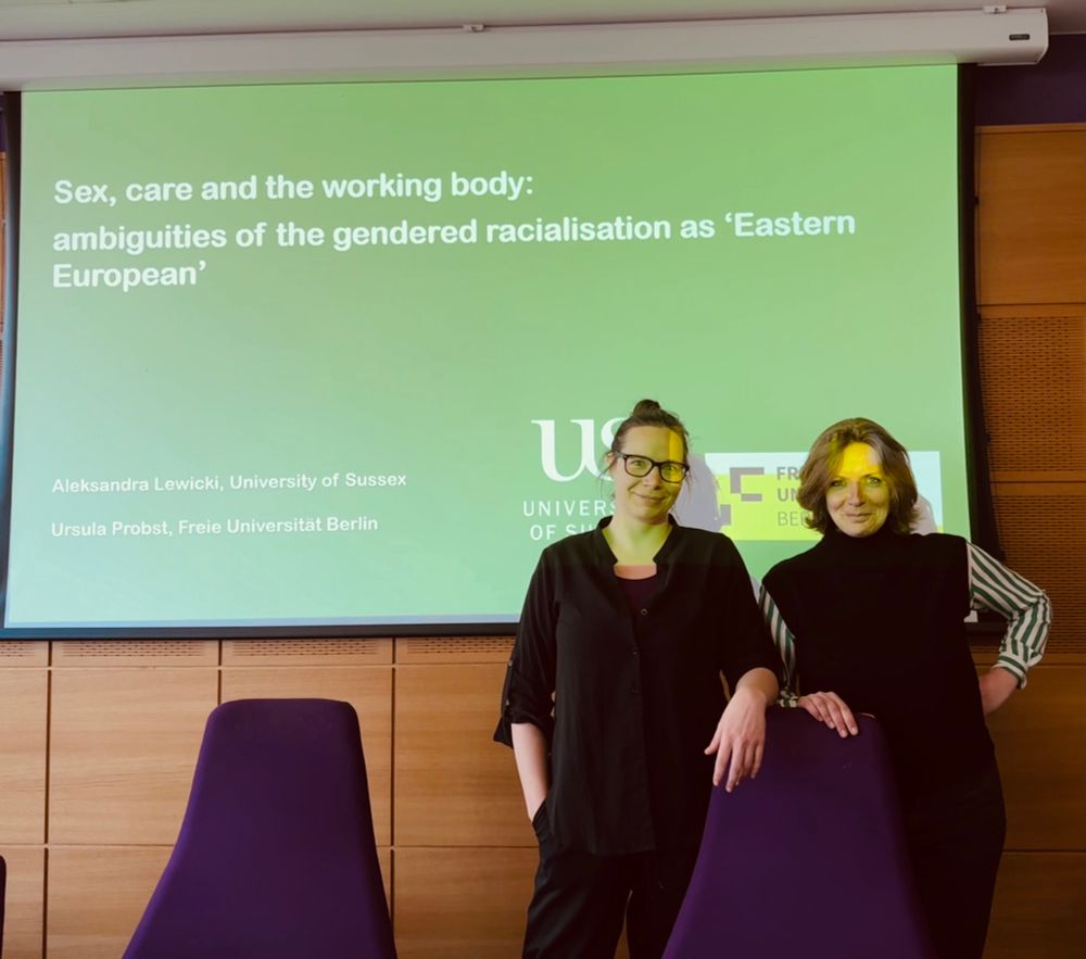 Photo of Ursula Probst and Aleks Lewicki in front of the presentation screen 