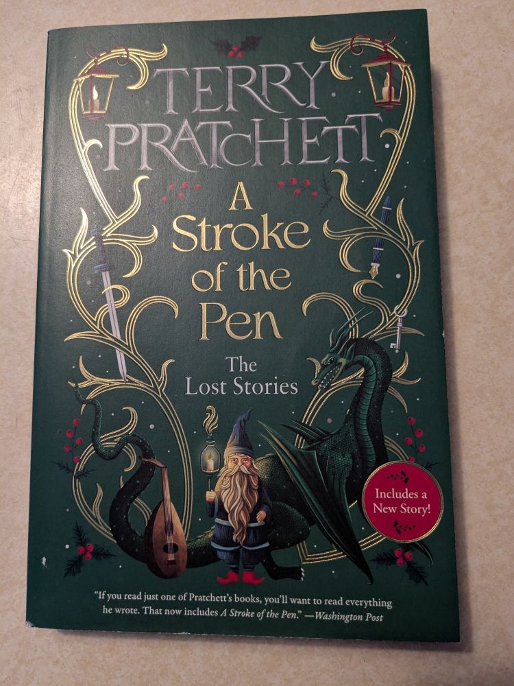 Gold vines (without leaves) twine up both sides.  Tucked in amongst the vines are things like a gnome, a dragon, a lute, a sword, a key, etc - all things from the stories.  Terry Pratchett is writ large in grey, the title - A Stroke of the Pen - is in shiny gold.  The background is green, lighter than pine but darker than grass.