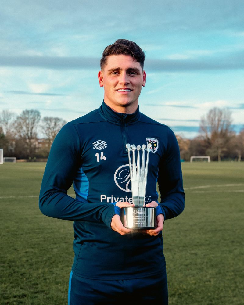 Matty Stevens holding his PFA League Two Fans’ Player of the Month award for November. 