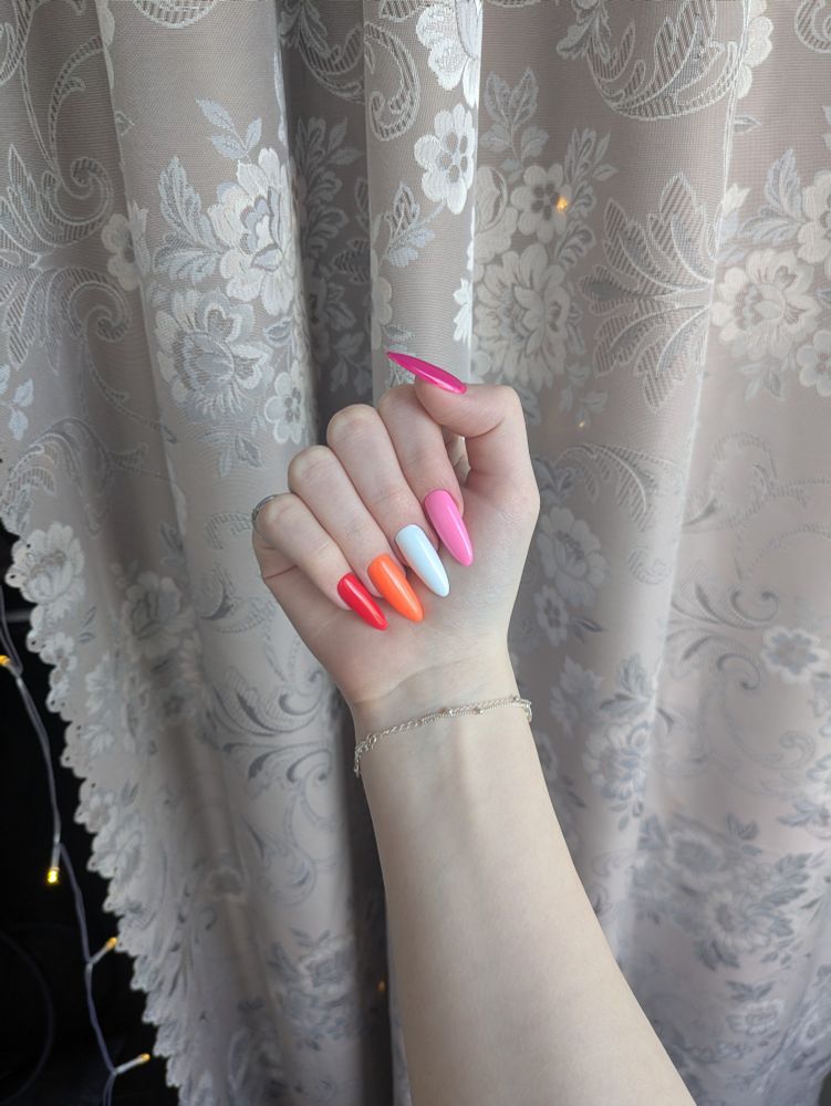 Nails painted in lesbian flag colors.