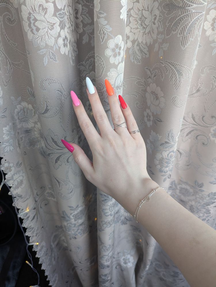 Nails painted in lesbian flag colors.