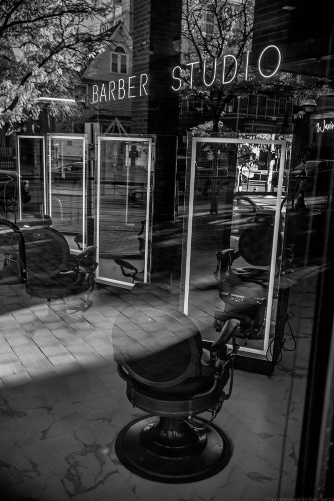 Looking into an empty barbershop decorated in postmodern rococo