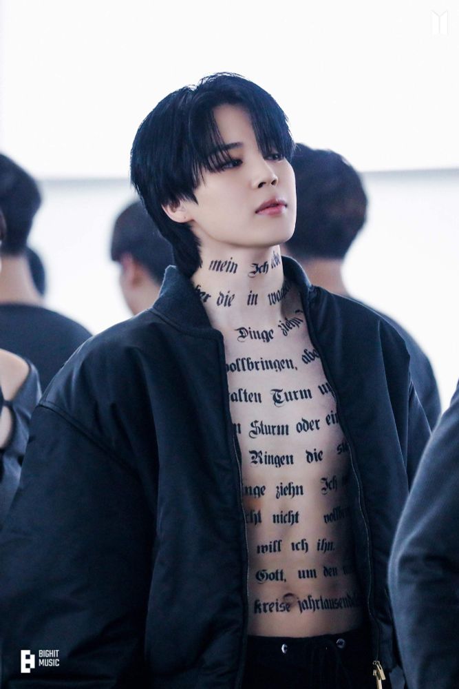 Set Me Free pt2 Jimin. Bomber jacket, no shirt (there's a pattern here), German poem on his chest, deadly stare