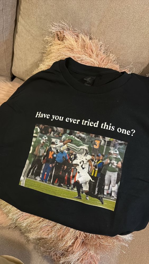 Saquon Barkley hurtle photo with the words “Have you ever tried this one?” above it. Aka such a clever Sabrina Carpenter x Eagles crossover merch that I need to buy right now. 