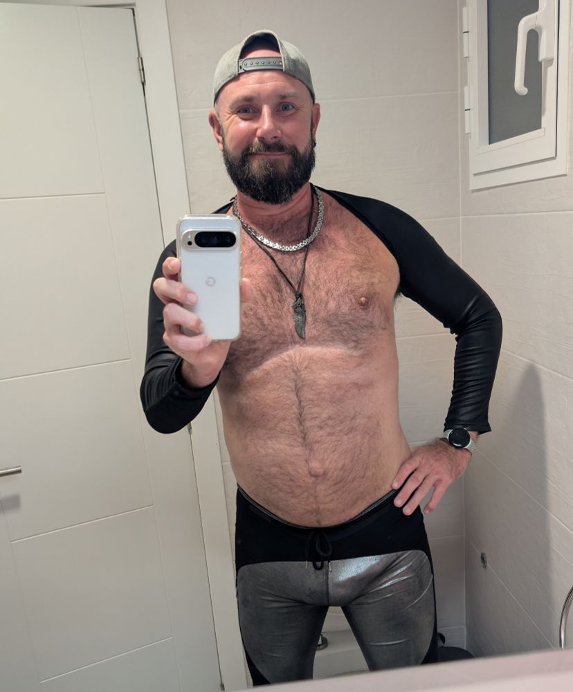 Bathroom selfie. I'm wearing lycra tights with silver highliting my groin and two black lycra arms. Cap on backwards. Nips and belly out for all to see. 