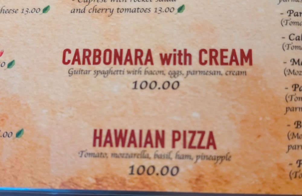 Photo of thef menu. Two things standing out: Carbonara with Cream Hawaian Pizza Both cost 100€