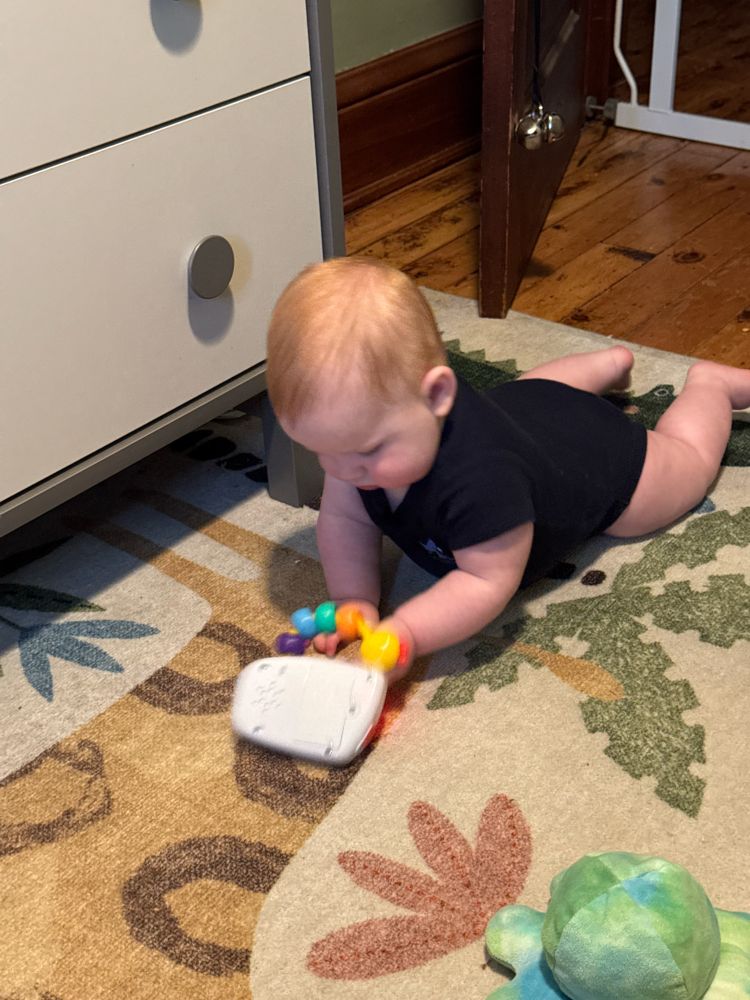 Baby playing on phone with toy phone