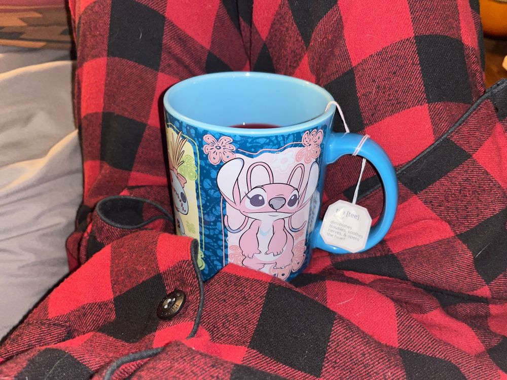 hibiscus tea in a lilo and stitch mug on my stomach 