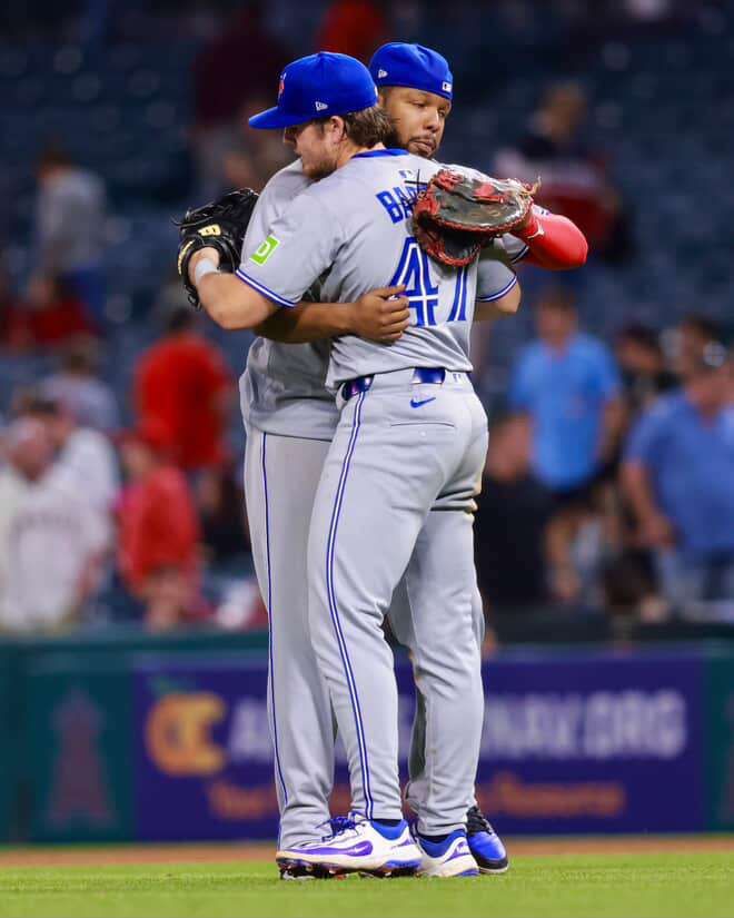 Vlad Guerrero jr and Addison Barger of the Blue Jays celebrate a win with a hug.